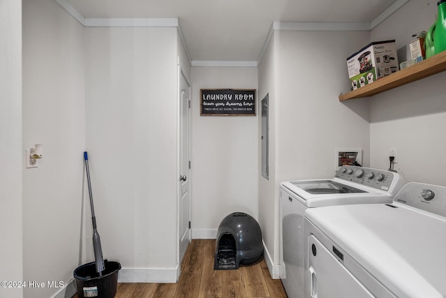 laundry room featuring ornamental molding, electric panel, separate washer and dryer, and dark wood-type flooring