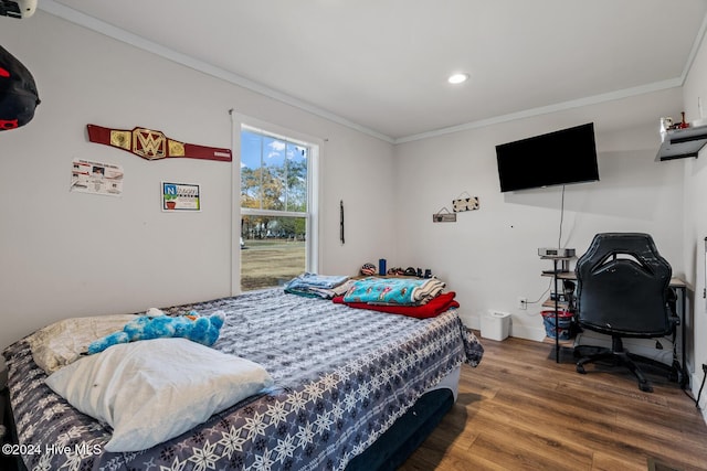 bedroom with wood-type flooring and ornamental molding