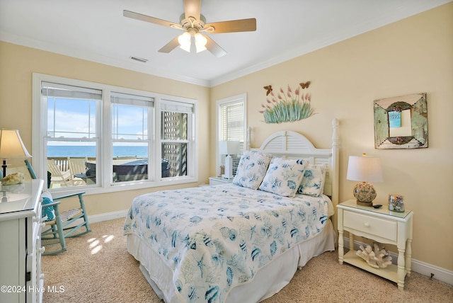 bedroom with crown molding, a water view, light carpet, and ceiling fan