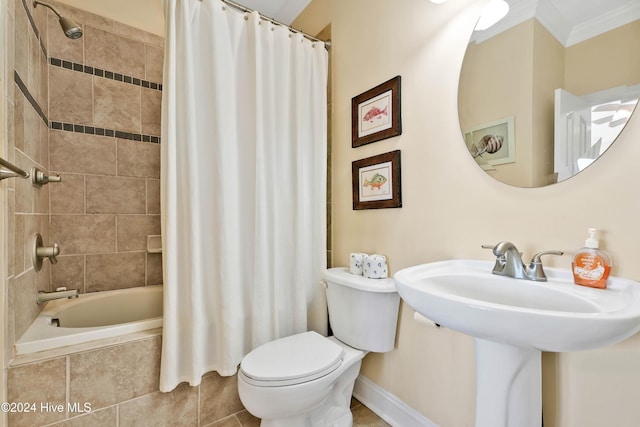 full bathroom with ornamental molding, sink, shower / bathtub combination with curtain, and toilet