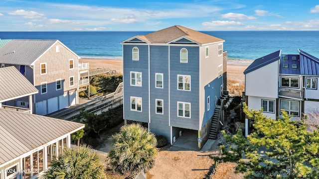 drone / aerial view with a water view and a beach view