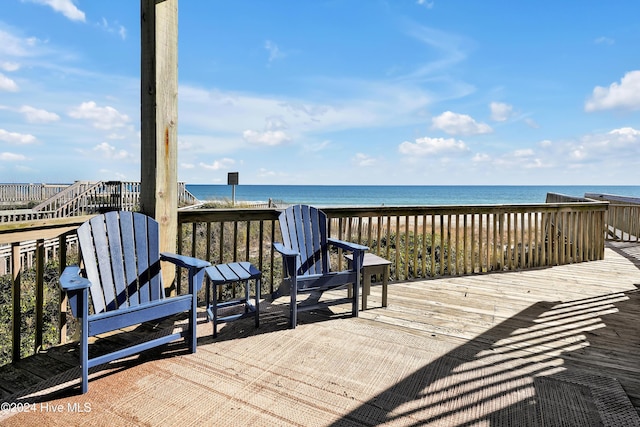 wooden terrace with a view of the beach and a water view