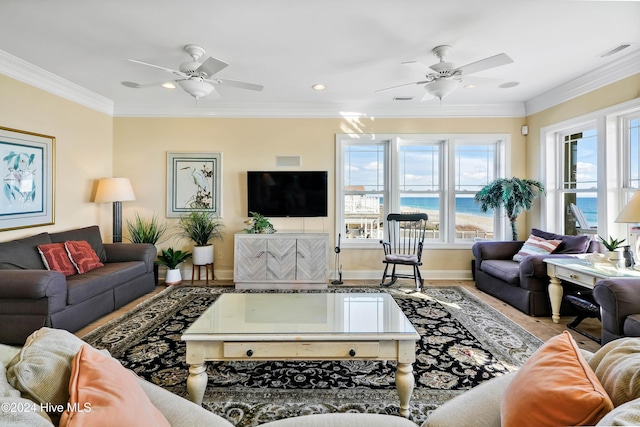 living room with crown molding, a healthy amount of sunlight, and ceiling fan