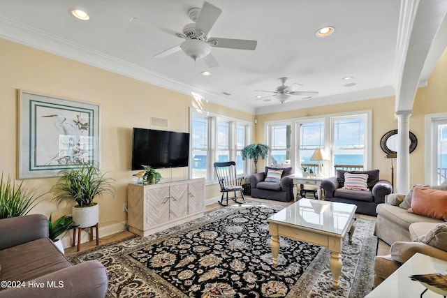 living room with ornate columns, ornamental molding, hardwood / wood-style floors, and ceiling fan