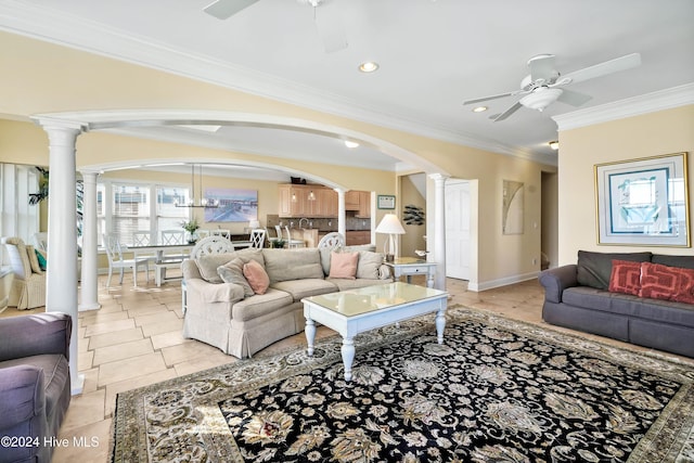 living room with ornate columns, ornamental molding, and ceiling fan