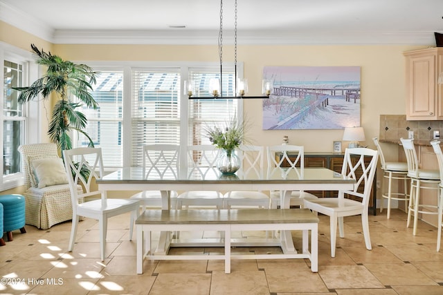 tiled dining room with crown molding and a notable chandelier