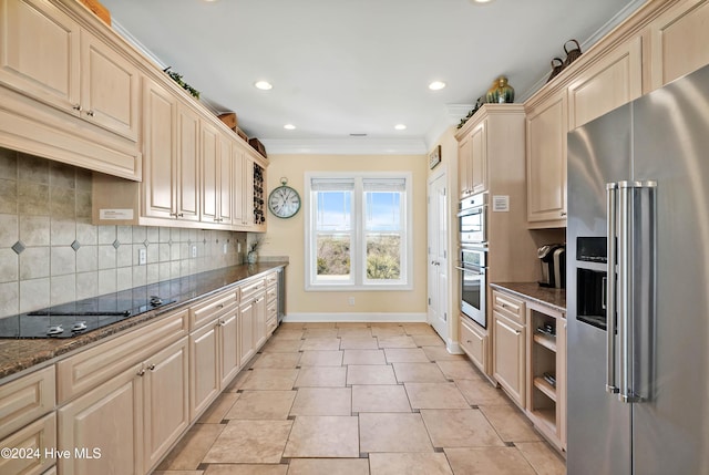 kitchen featuring light tile patterned flooring, dark stone counters, decorative backsplash, stainless steel appliances, and crown molding