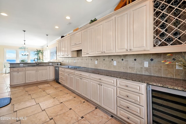 kitchen featuring decorative light fixtures, sink, wine cooler, backsplash, and black electric stovetop