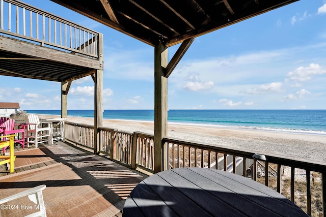 exterior space with a water view and a view of the beach