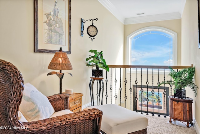 sitting room with ornamental molding and carpet floors