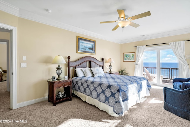 bedroom with access to exterior, carpet floors, ornamental molding, and a water view