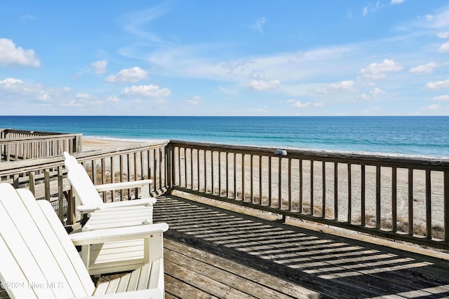 deck with a water view and a beach view