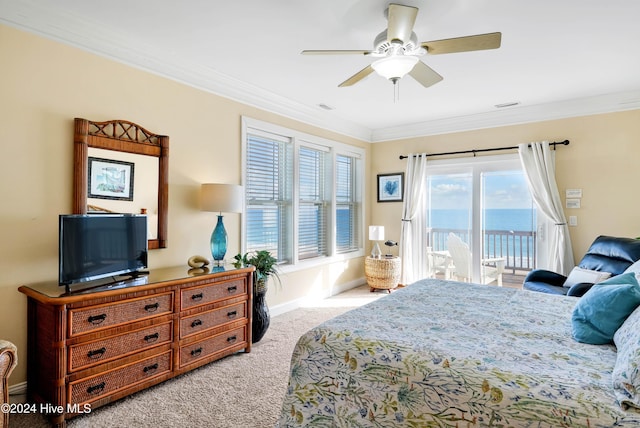 bedroom with ornamental molding, a water view, light colored carpet, and access to exterior