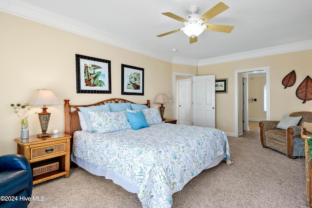 carpeted bedroom featuring crown molding and ceiling fan