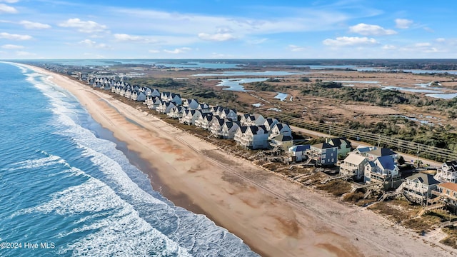 birds eye view of property featuring a view of the beach and a water view