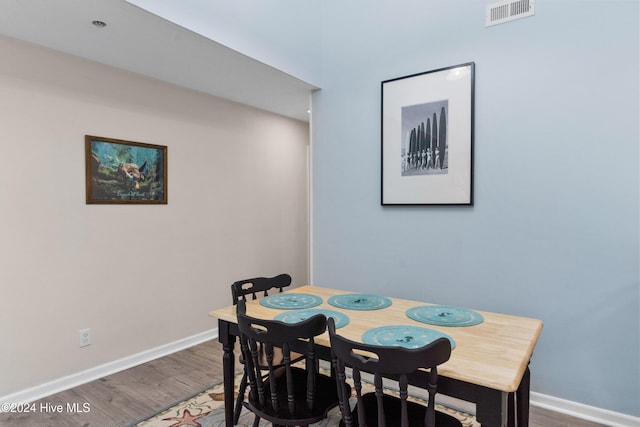 dining space with hardwood / wood-style floors