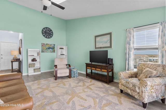 living area featuring hardwood / wood-style flooring, ceiling fan, and lofted ceiling