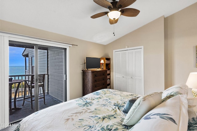 bedroom with lofted ceiling, ceiling fan, access to exterior, a water view, and a closet