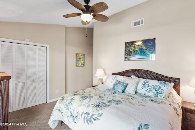 carpeted bedroom featuring vaulted ceiling, ceiling fan, and a closet