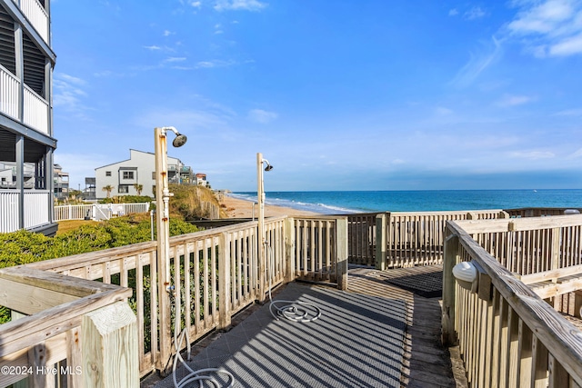 surrounding community featuring a water view and a view of the beach