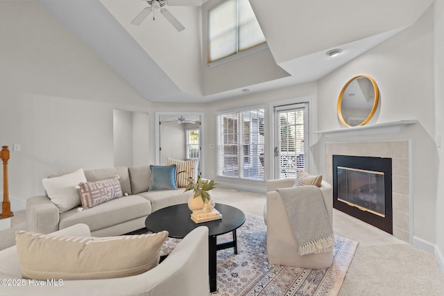 carpeted living area featuring ceiling fan and a tile fireplace