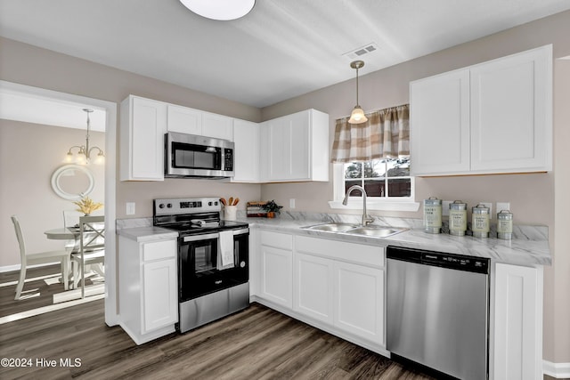 kitchen with sink, white cabinetry, stainless steel appliances, and dark wood-type flooring