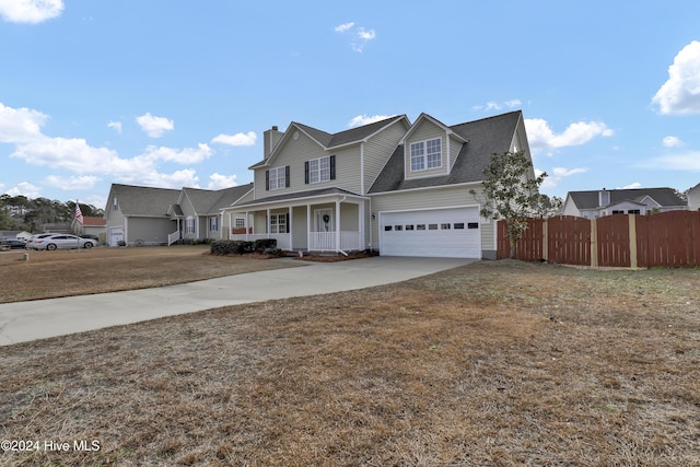 view of front property with a front lawn, a porch, and a garage