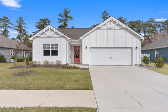 modern farmhouse style home featuring a front yard and a garage