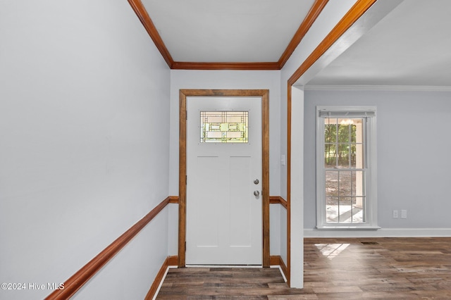 foyer with ornamental molding, dark wood-style flooring, visible vents, and baseboards