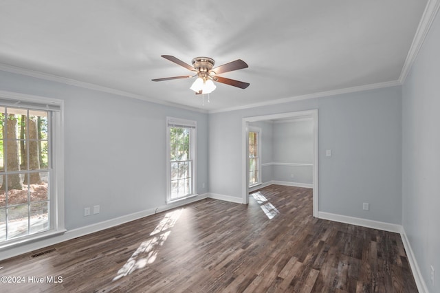 unfurnished room with a healthy amount of sunlight, visible vents, and dark wood finished floors