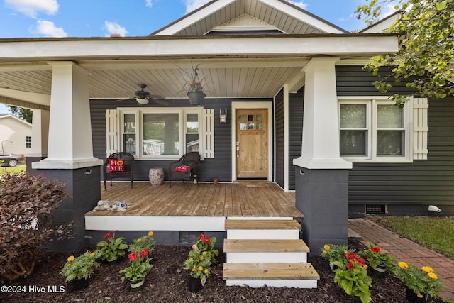 doorway to property with a porch and ceiling fan