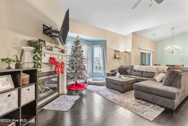 living room with hardwood / wood-style floors and ceiling fan with notable chandelier