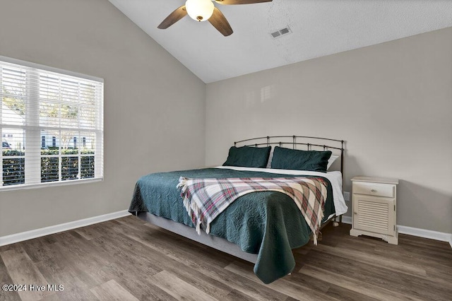 bedroom with wood-type flooring, a textured ceiling, high vaulted ceiling, and ceiling fan