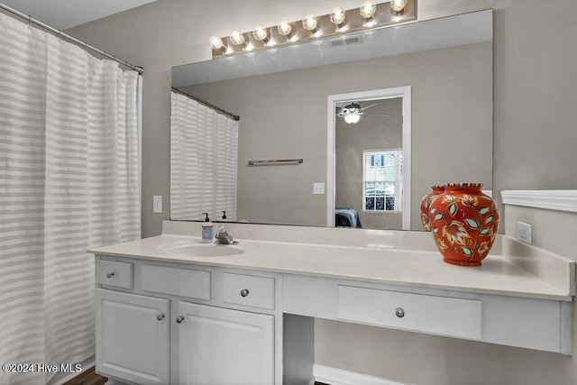 bathroom featuring a textured ceiling, vanity, and ceiling fan