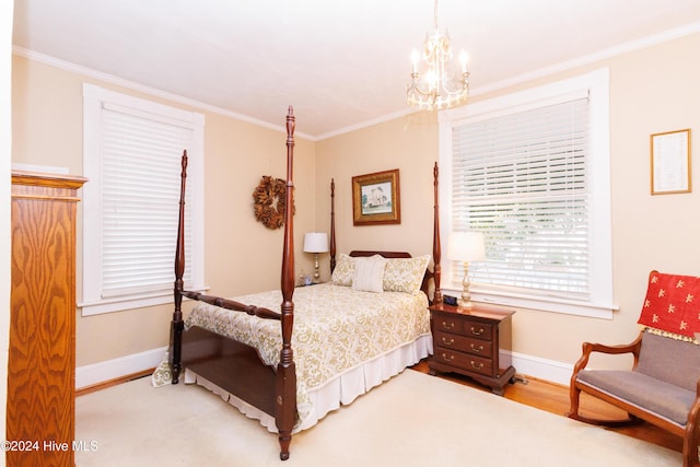 bedroom with hardwood / wood-style flooring, a notable chandelier, and ornamental molding