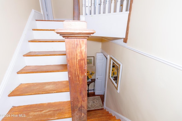 stairway with hardwood / wood-style flooring