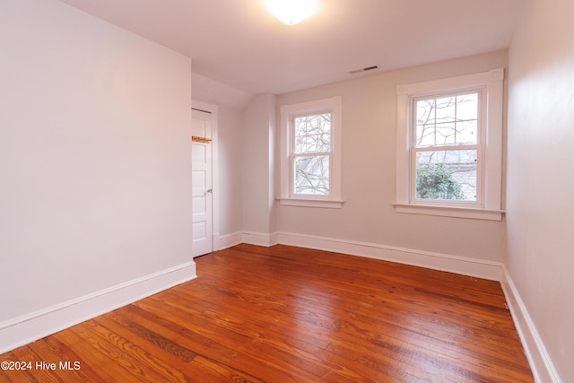 spare room featuring wood-type flooring and a wealth of natural light