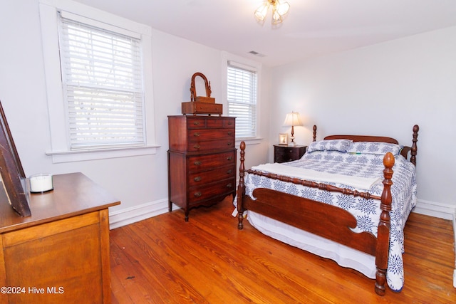 bedroom with hardwood / wood-style flooring