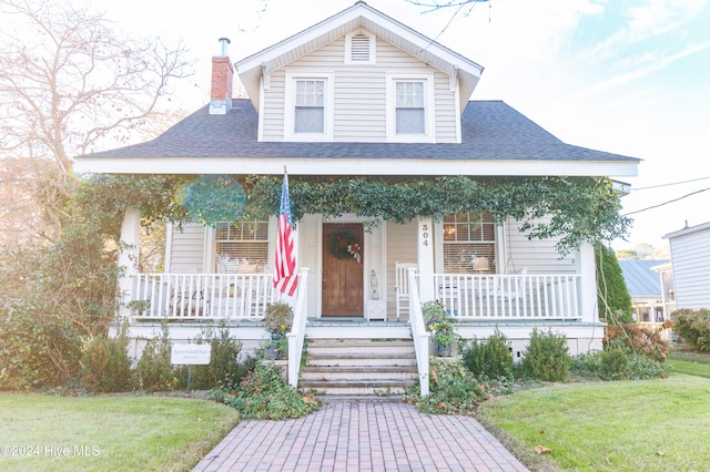 bungalow-style home featuring a front yard and a porch