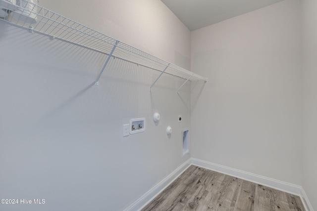 laundry area featuring hookup for a gas dryer, light hardwood / wood-style flooring, washer hookup, and hookup for an electric dryer