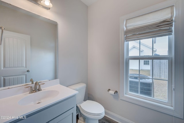 bathroom featuring vanity, hardwood / wood-style flooring, and toilet