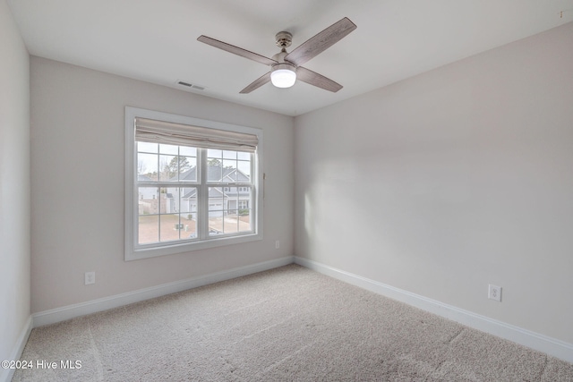 spare room featuring ceiling fan and carpet floors