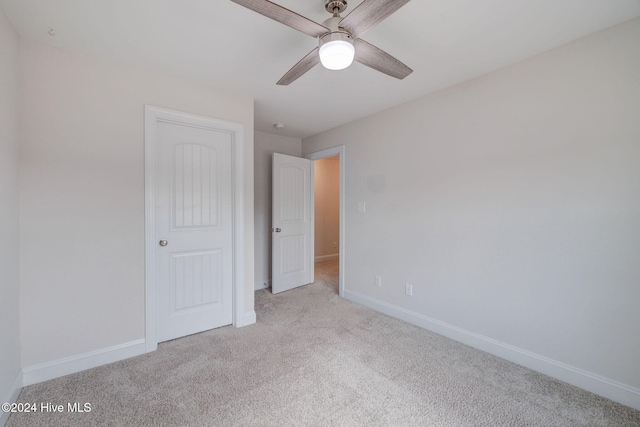 unfurnished bedroom with light colored carpet and ceiling fan