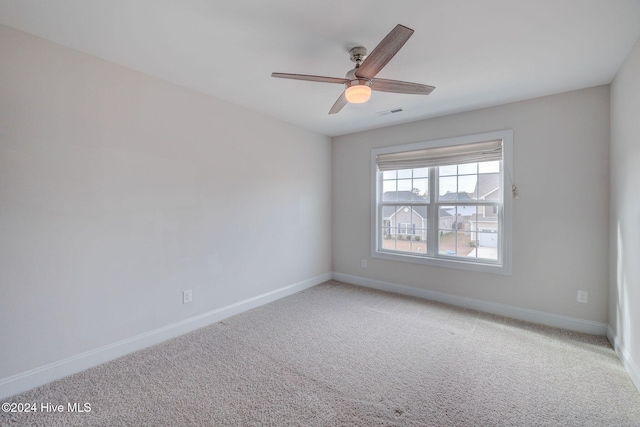 spare room with carpet floors and ceiling fan