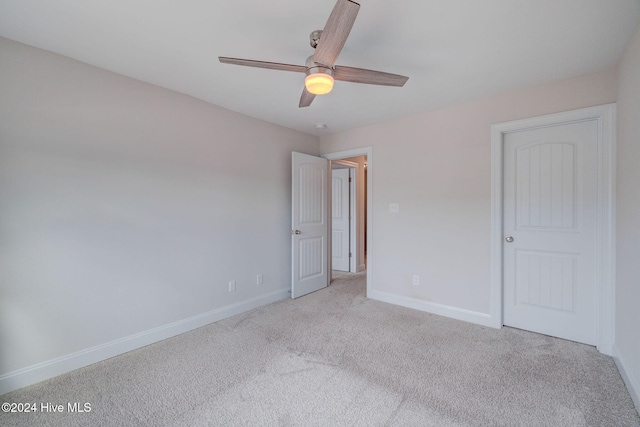 unfurnished bedroom featuring ceiling fan and light colored carpet