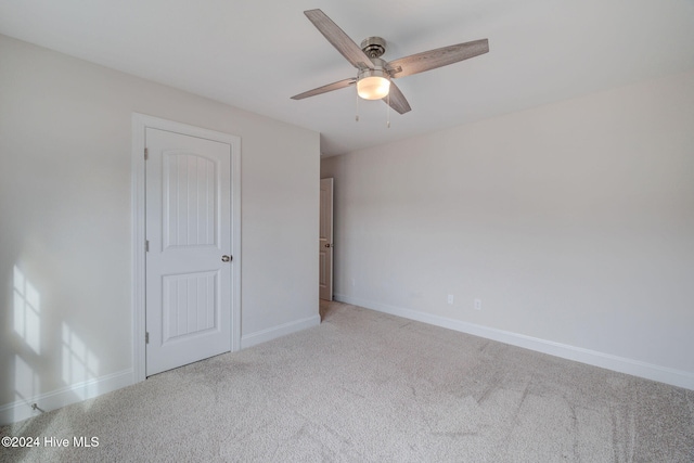 unfurnished bedroom with ceiling fan and light colored carpet