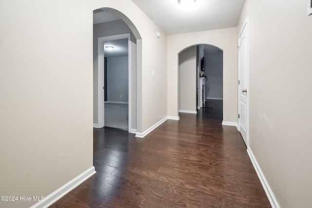 hall with dark hardwood / wood-style flooring