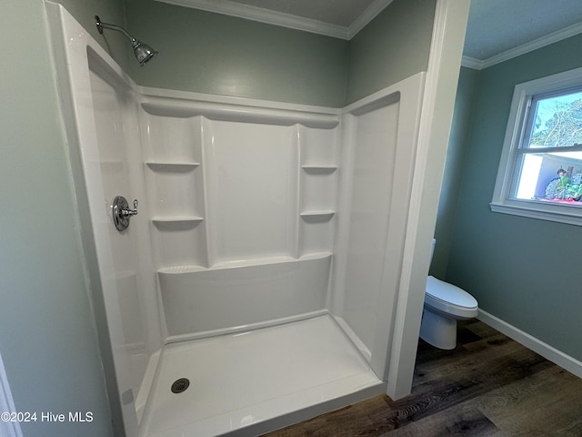 bathroom with a shower, toilet, ornamental molding, and hardwood / wood-style flooring