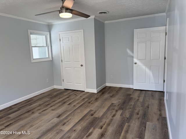 unfurnished bedroom featuring ceiling fan, dark hardwood / wood-style flooring, and crown molding