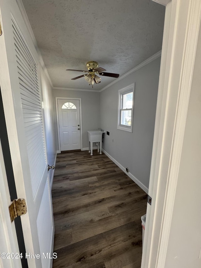 laundry area featuring ceiling fan, dark hardwood / wood-style flooring, a textured ceiling, and ornamental molding